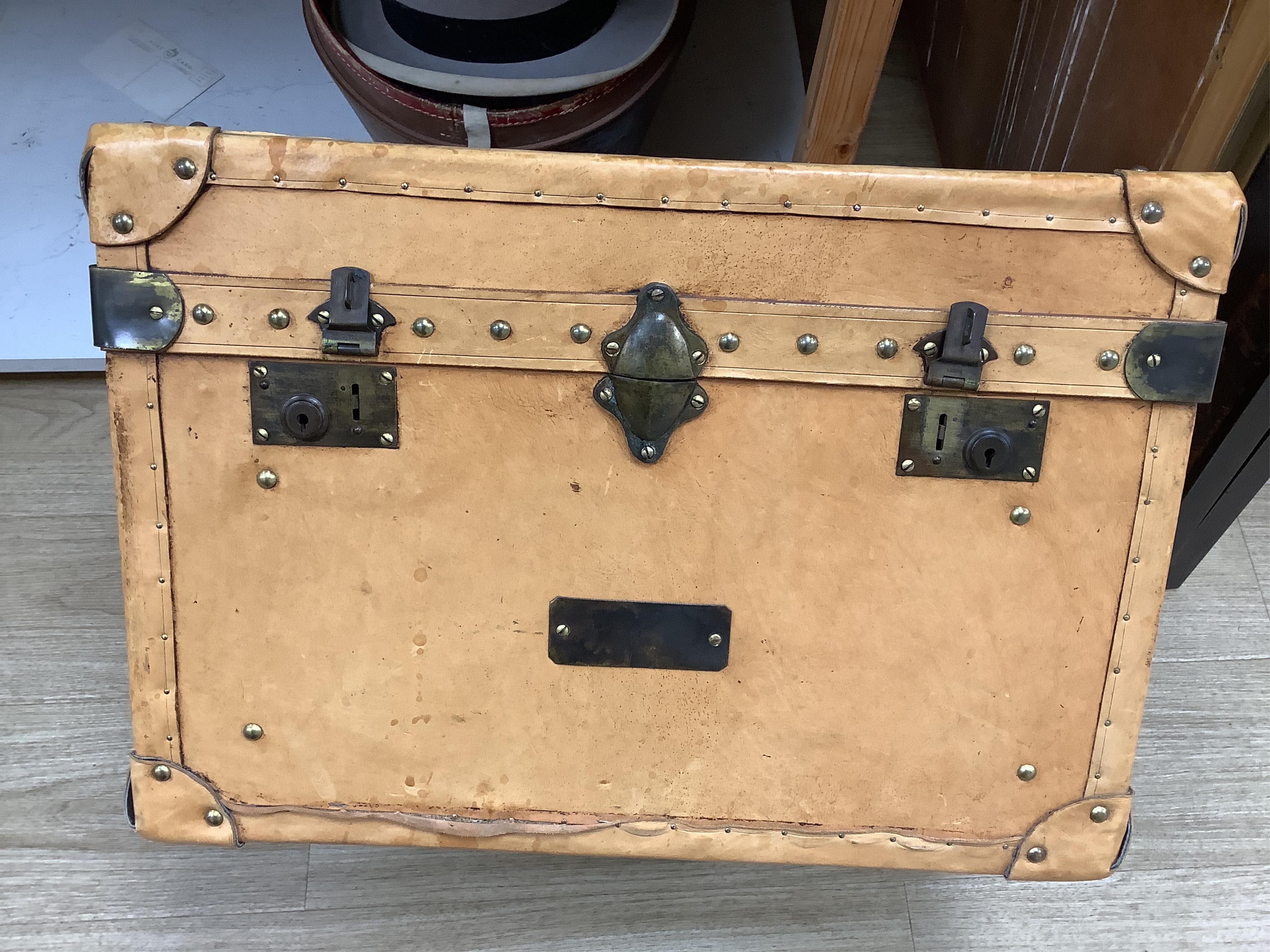 A leather trunk and top hat in box